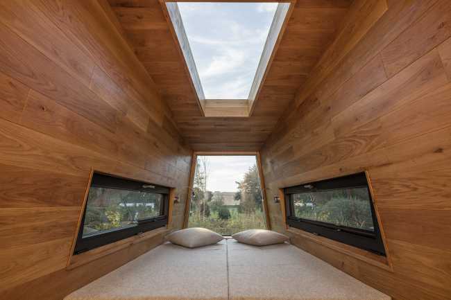 Floating Sculpted Space. The bronze colored facade elegantly reflects the environment