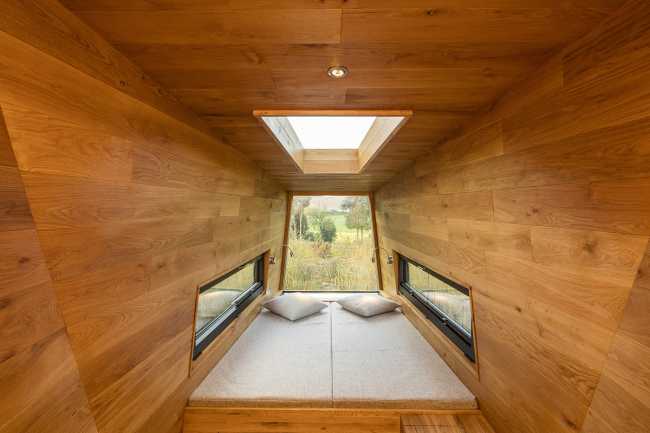 Floating Sculpted Space. The bronze colored facade elegantly reflects the environment