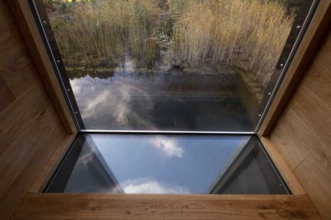 Floating Sculpted Space. The bronze colored facade elegantly reflects the environment