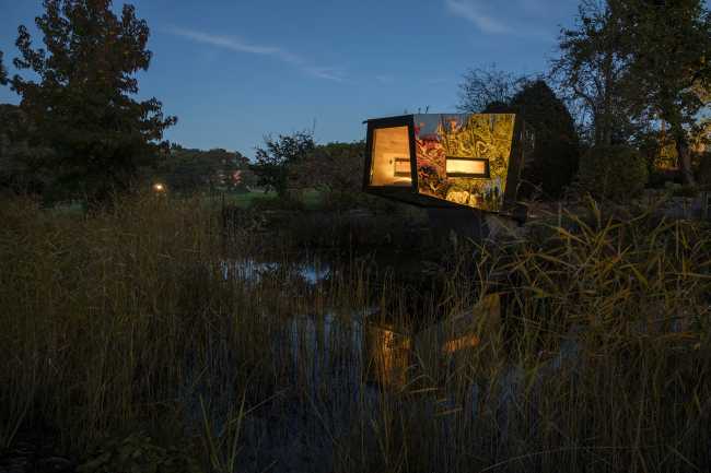 Floating Sculpted Space. The bronze colored facade elegantly reflects the environment