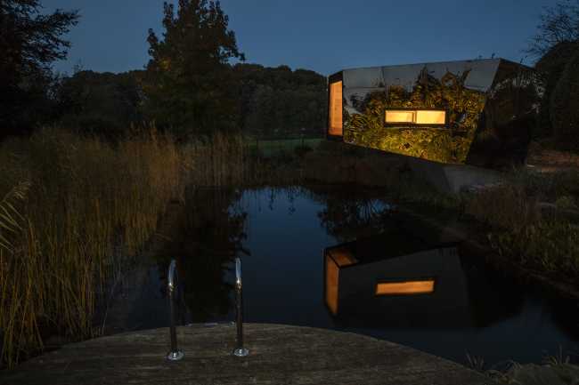 Floating Sculpted Space. The bronze colored facade elegantly reflects the environment