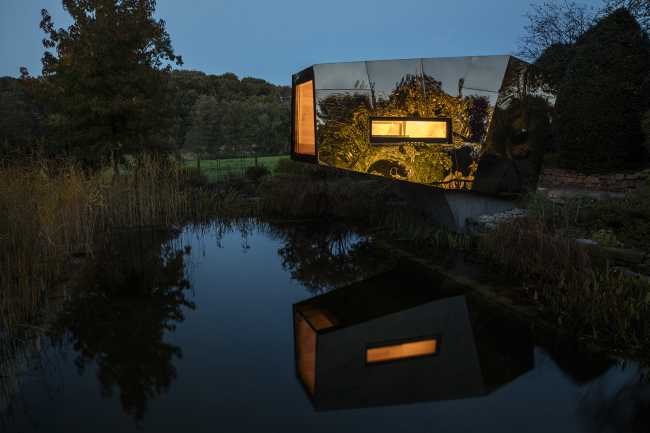 Floating Sculpted Space. The bronze colored facade elegantly reflects the environment