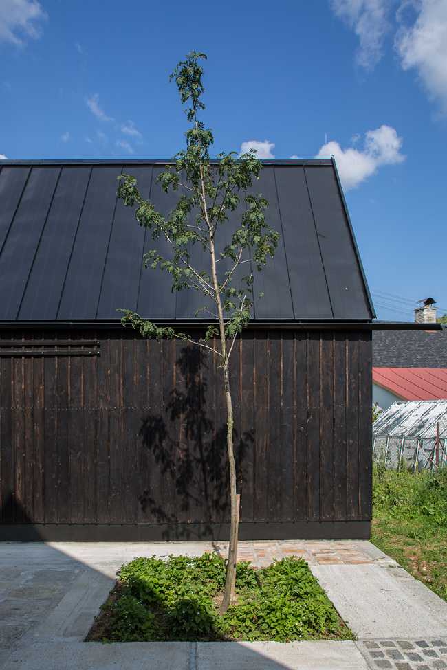 The old barn gives way to a small wooden house. Monumental granite walls preserved