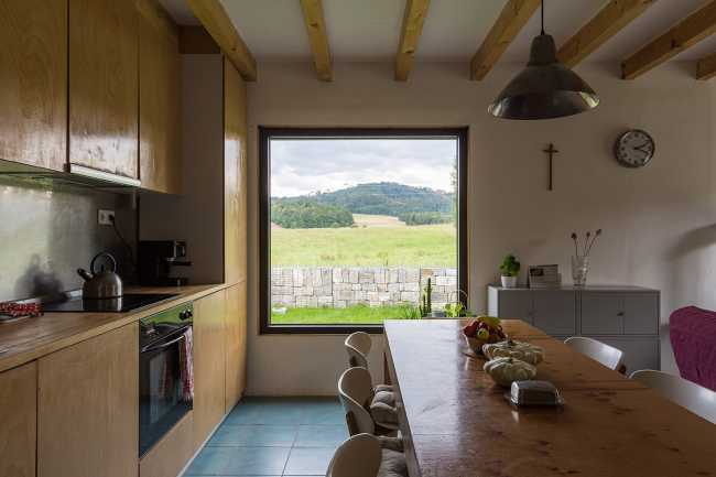 The old barn gives way to a small wooden house. Monumental granite walls preserved