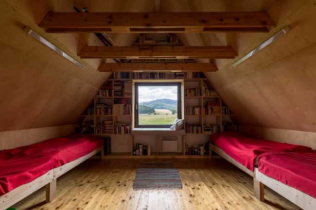 The old barn gives way to a small wooden house. Monumental granite walls preserved