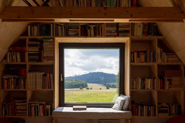The old barn gives way to a small wooden house. Monumental granite walls preserved