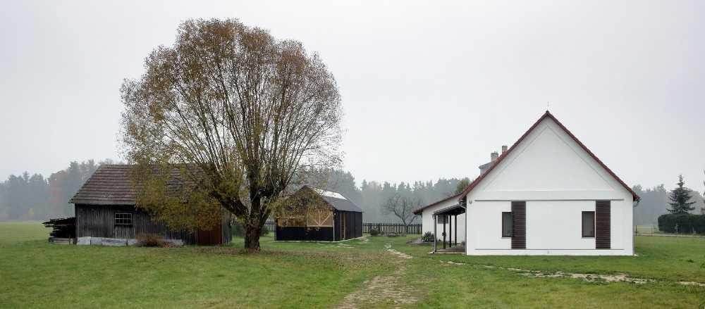 Farm surrounded by the picturesque Bohemian nature. New wooden farm building