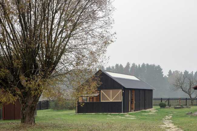 Farm surrounded by the picturesque Bohemian nature. New wooden farm building
