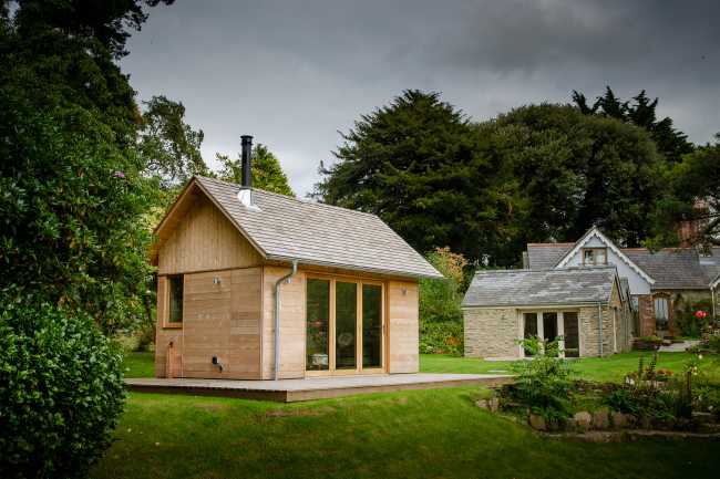 Ambiances pour la détente et le partage. Une cabane en cèdre ravive le jardin de la maison de vacances.