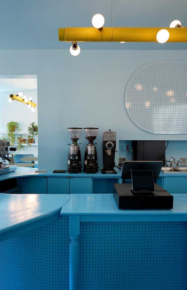 Tipico Cafè di New York. Tavoli di recupero formano bancone blu che massimizza le interazioni sociali