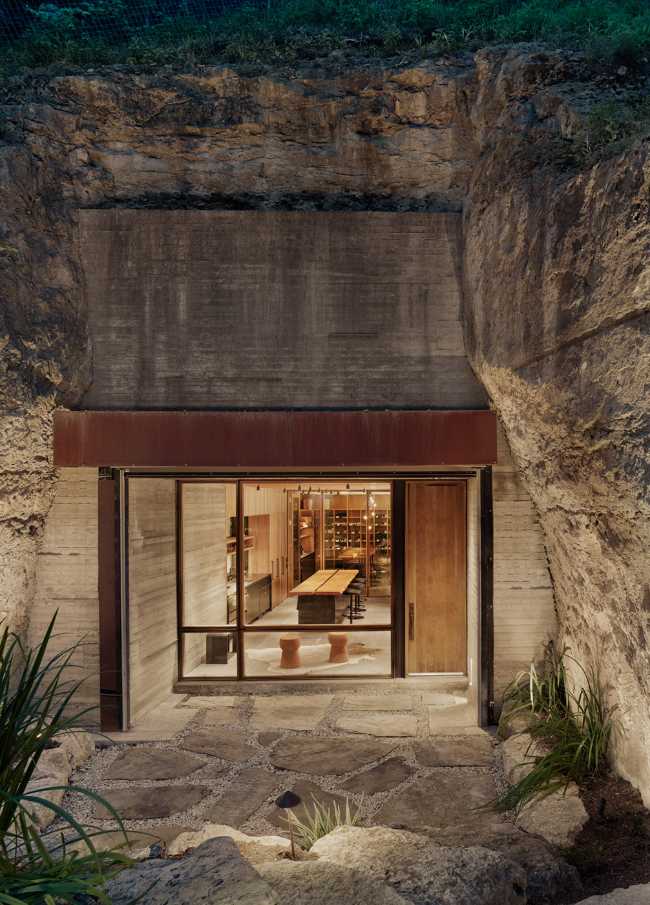 Wine shop carved in the rock. Tasting wine inside a small cave