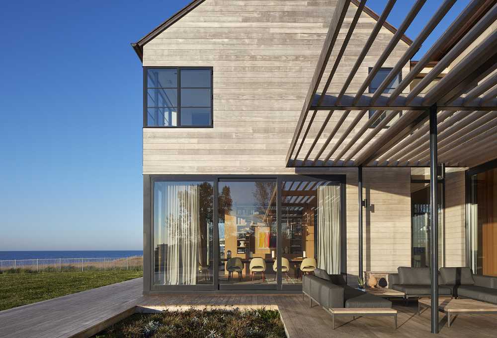 St. Joseph Residence: group of vernacular volumes rest on a green lawn overlooking the lake