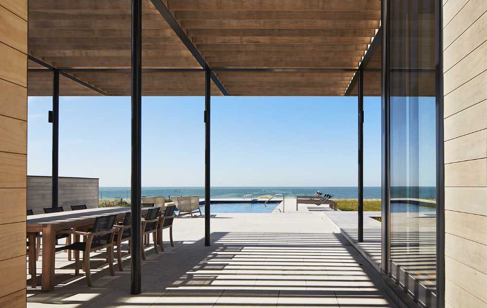 St. Joseph Residence: group of vernacular volumes rest on a green lawn overlooking the lake