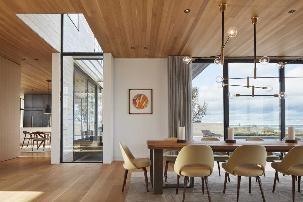 St. Joseph Residence: group of vernacular volumes rest on a green lawn overlooking the lake