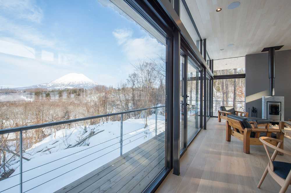 Architectural dialogue between cedar and metal for the Hiyoku home, a backdrop of Japan's snow-capped mountains