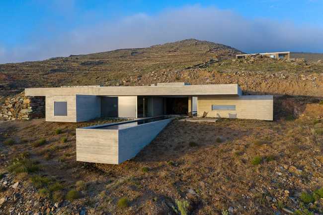 Lap Pool House: an artificial cave carved into the natural landscape of a Greek island