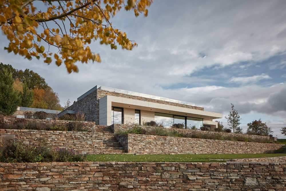 The stone wraps around a villa built on a slope in the Bohemian Paradise