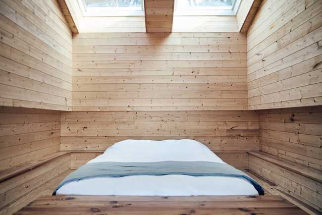 Wooden suites at the Grand Cepage Hotel, resembling the sophisticated nests among the reeds, are reflected in the lake for a primordial living experience