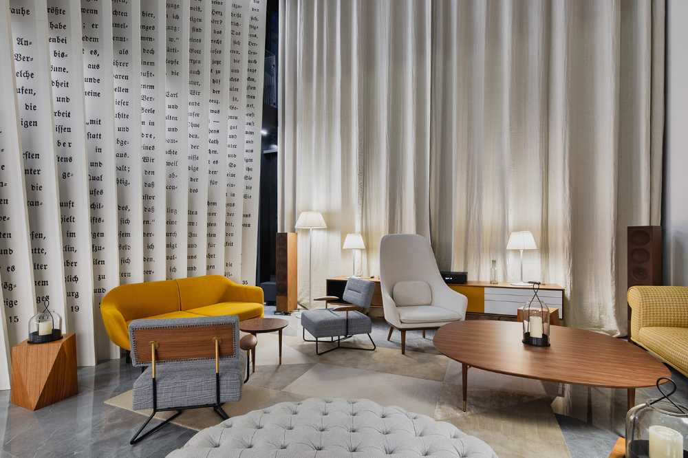 Huge wooden books create the space for the Lobby of the Philosophers Residence in Latvia