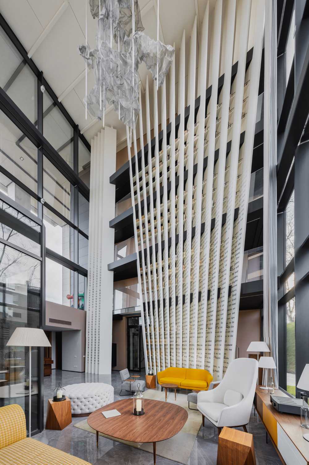 Huge wooden books create the space for the Lobby of the Philosophers Residence in Latvia