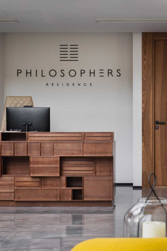 Enormi libri in legno creano lo spazio per la Lobby del Philosophers Residence in Lettonia