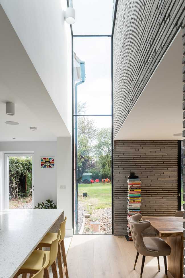 Long Brick House. Une boîte de briques en pierre reliée à la structure préexistante par un couloir vitré