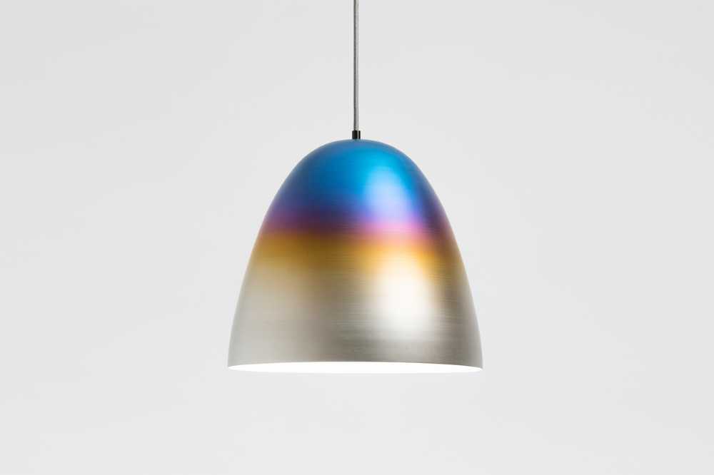 Burning metal. The combustion of metal creates iridescent shades for a line of design objects