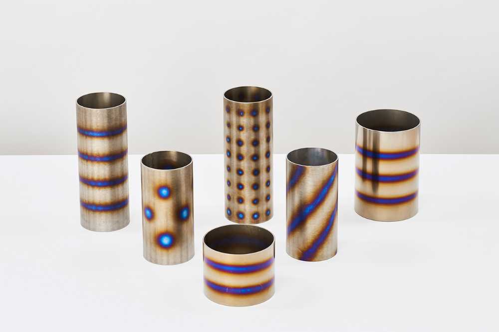 Burning metal. The combustion of metal creates iridescent shades for a line of design objects