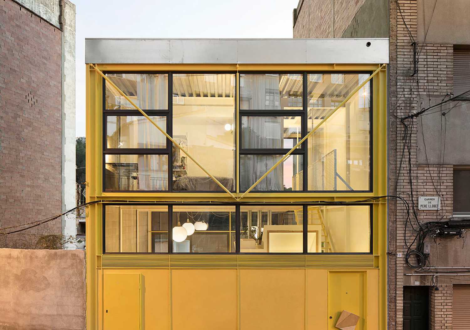 Giallo per una struttura metallica che “cattura” lo spazio per una casa al centro di Barcellona