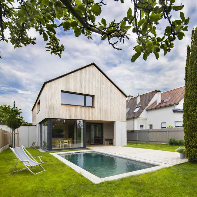 House W1T in legno e cemento per un abitare sostenibile e un’architettura dai volumi dinamici