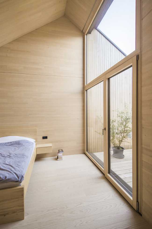 House W1T in legno e cemento per un abitare sostenibile e un’architettura dai volumi dinamici