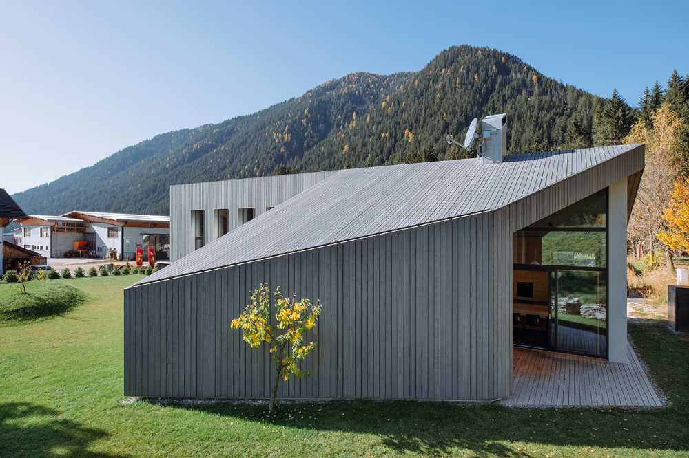 Wood cladding and blackened steel details featured in House L in an effort to integrate the architecture into a protected natural area
