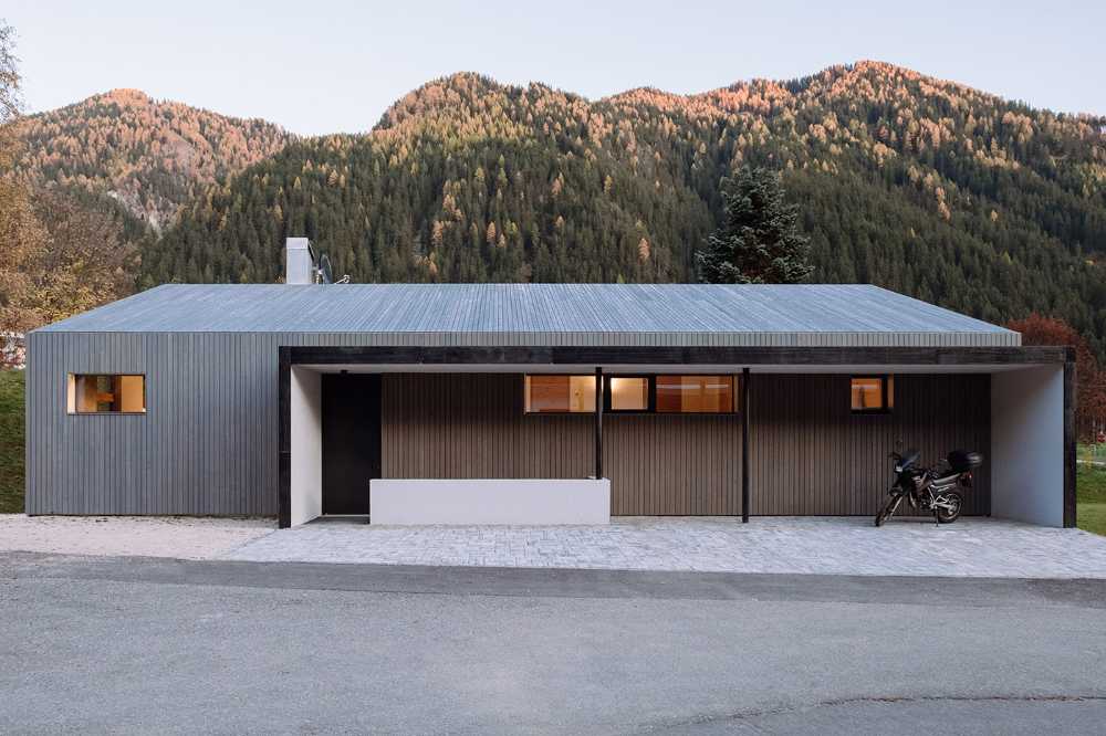 Wood cladding and blackened steel details featured in House L in an effort to integrate the architecture into a protected natural area
