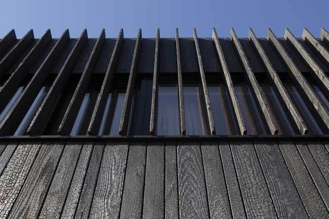Burnt wood and an energetic neutrality in the silky Dutch Black House
