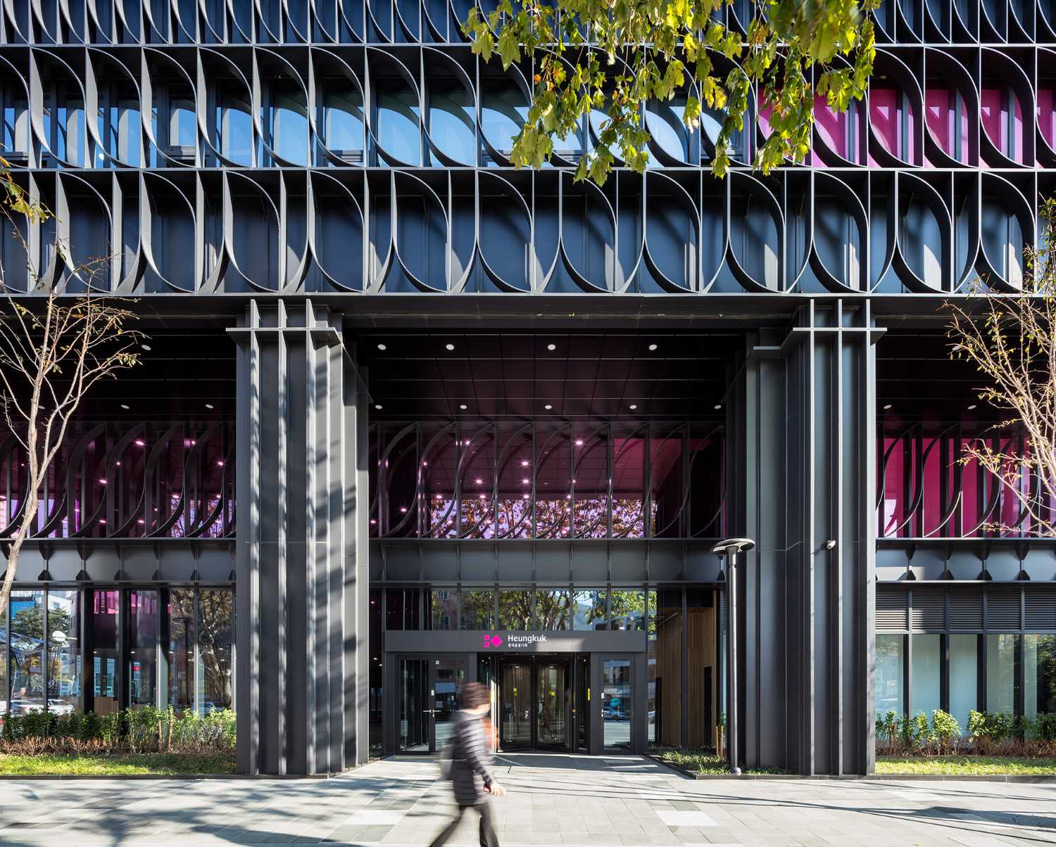 Elementos lineales para la fachada de la Torre Heungkuk de Busan teñidos de negro y fucsia