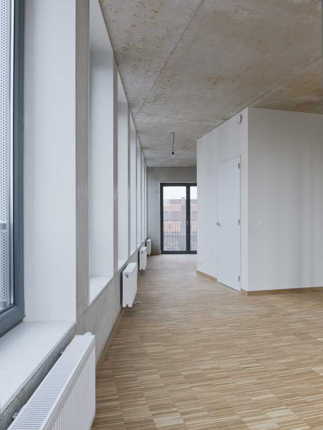 Zegel a mixed-function building with an exuberant structure toned down by the lightweight aluminum façade shell