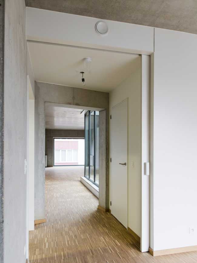 Zegel a mixed-function building with an exuberant structure toned down by the lightweight aluminum façade shell