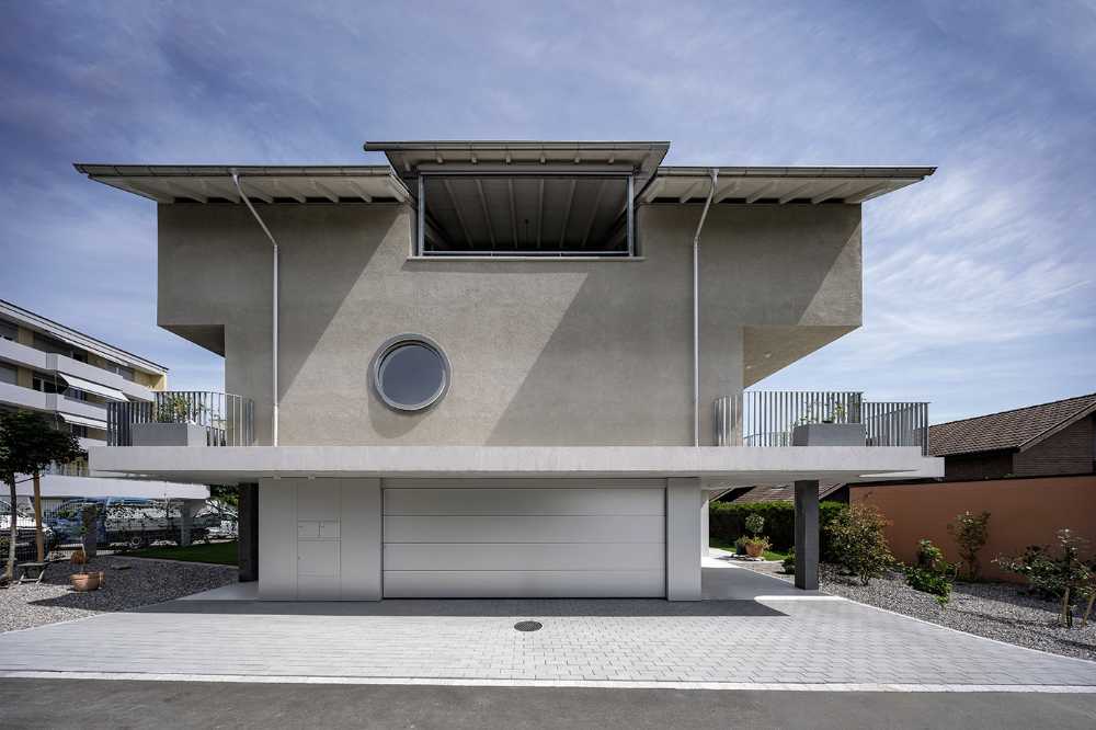 House for two families in Lucerne. A rigorous floating structure attenuated by playful openings