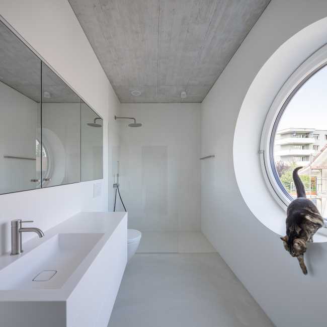 House for two families in Lucerne. A rigorous floating structure attenuated by playful openings