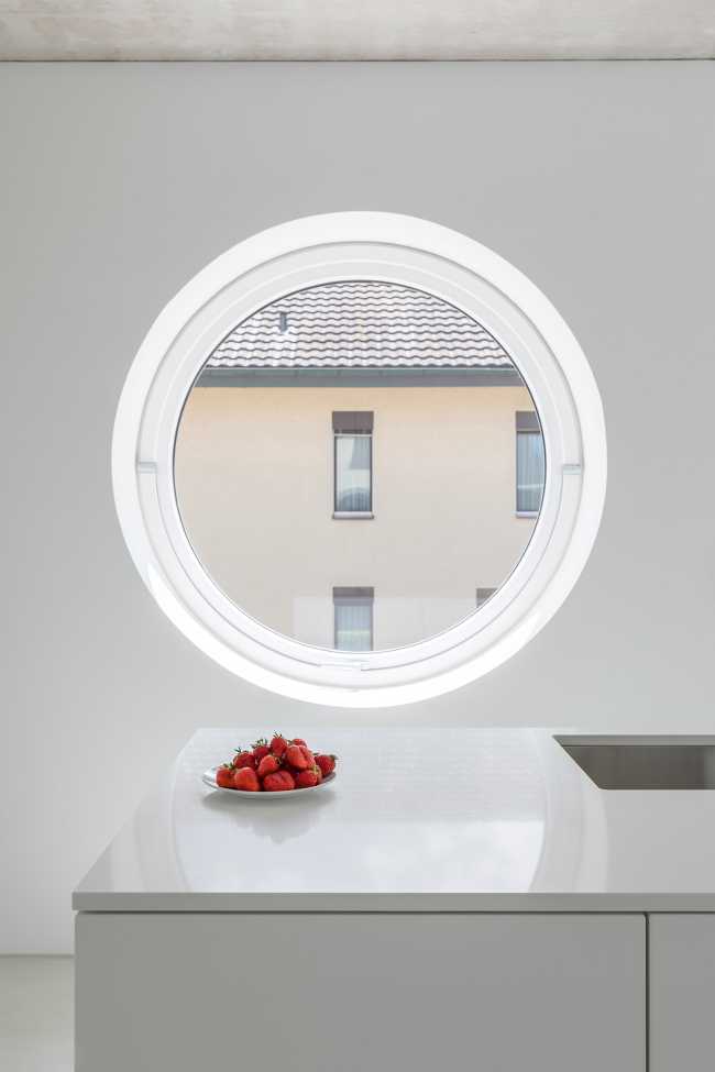 House for two families in Lucerne. A rigorous floating structure attenuated by playful openings