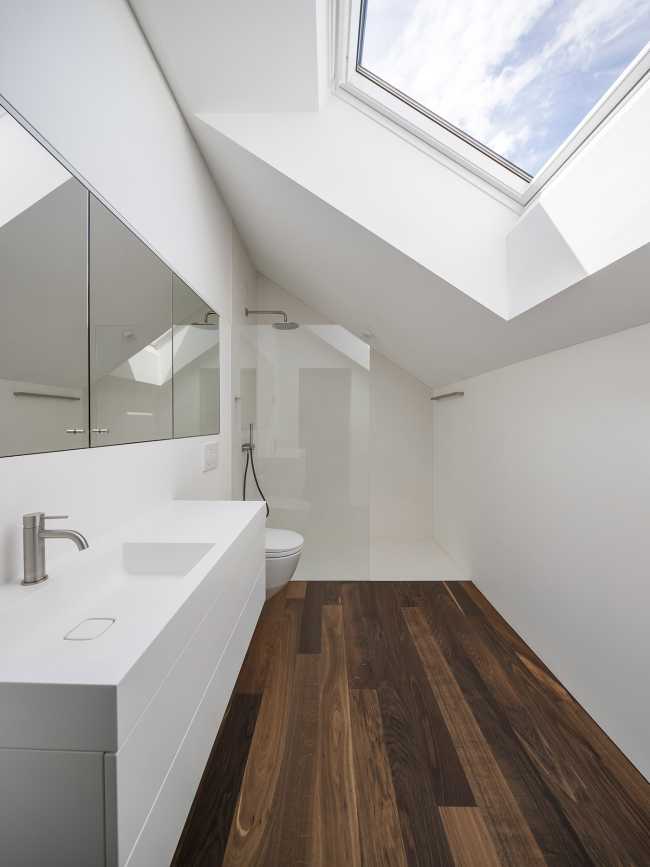 House for two families in Lucerne. A rigorous floating structure attenuated by playful openings