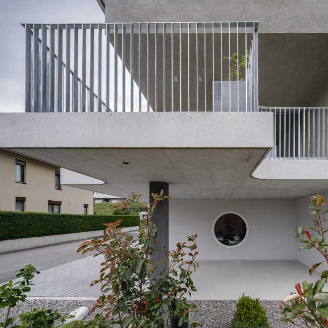 House for two families in Lucerne. A rigorous floating structure attenuated by playful openings