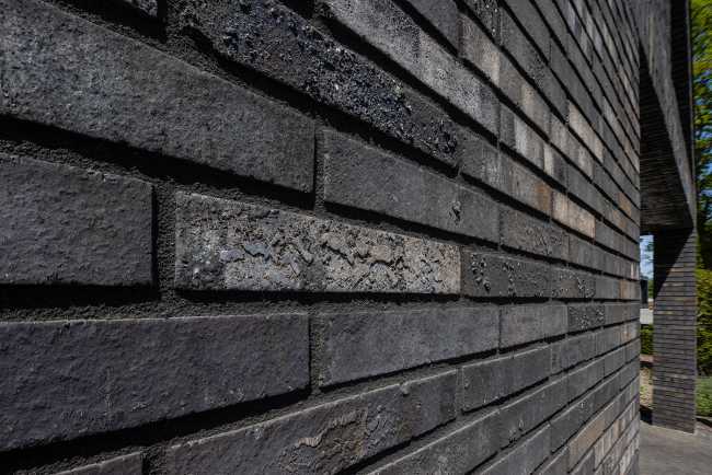 Nestled in the lap of an ancient medieval agricultural area, the former site of an automobile company transforms into a