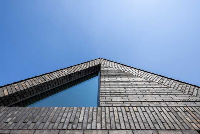 Nestled in the lap of an ancient medieval agricultural area, the former site of an automobile company transforms into a