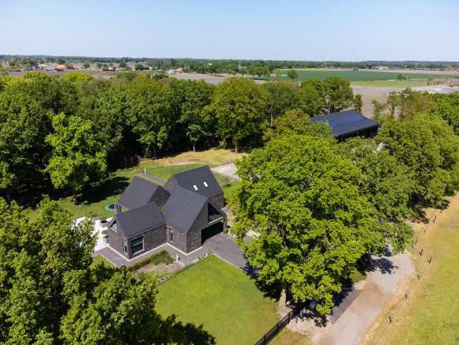 Nestled in the lap of an ancient medieval agricultural area, the former site of an automobile company transforms into a