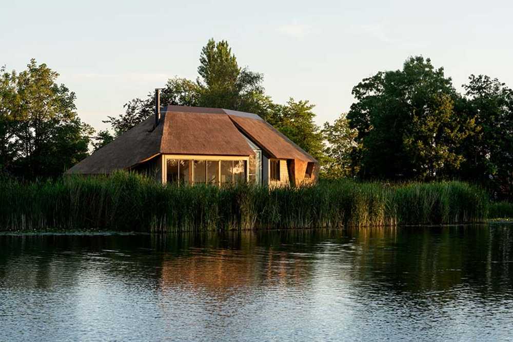 Dutch Dike House. A stunning glass fissure transforms the traditional structure