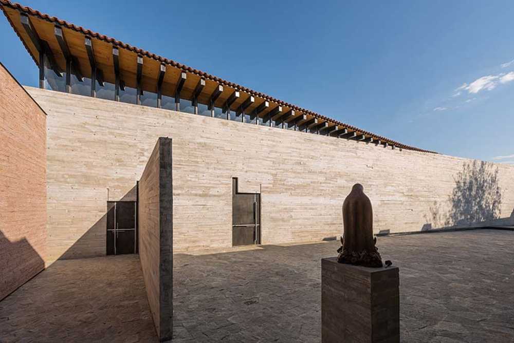 RLJ Chapel. Exposed Concrete and Steel Contrasting with Natural Materials