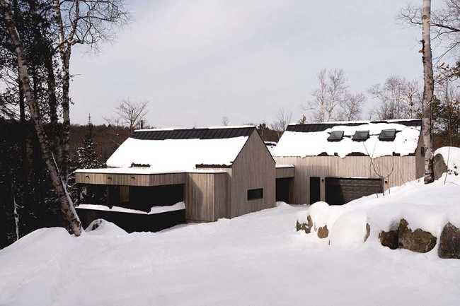 Varied volumetrics and local materials of the La Tierce residence for a living experience intimately linked with nature