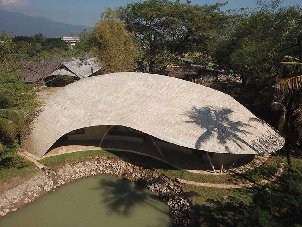 Architecture studio on water's edge. Organic temple of creativity