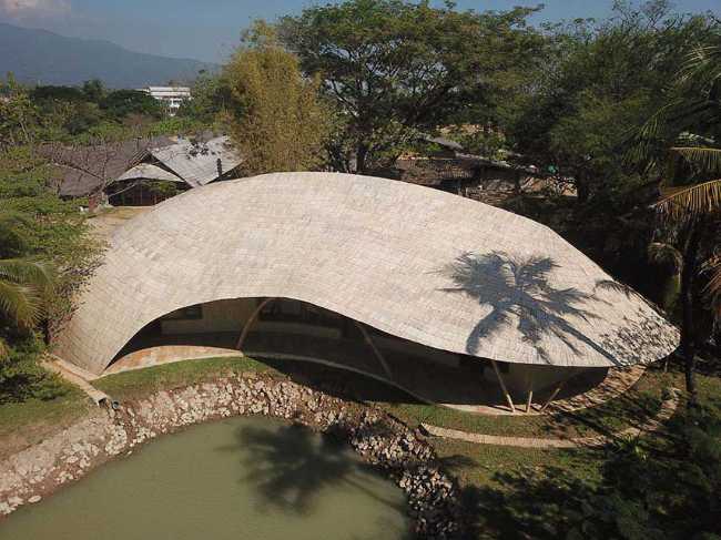 Architecture studio on water's edge. Organic temple of creativity